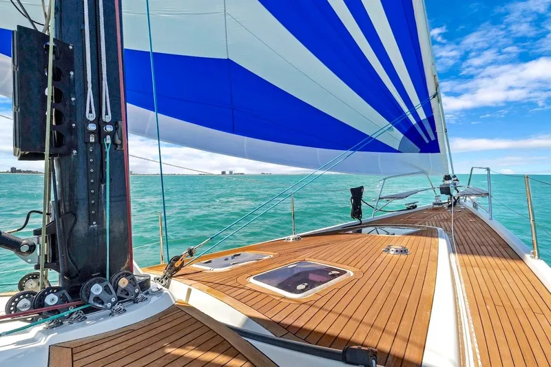 Slide: The Image of Sailing on a 2011 Southerly 57 RS yacht with blue and white sails over turquoise waters. - 9