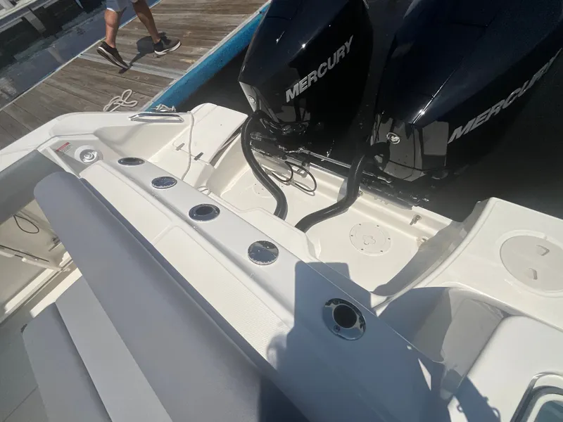 Slide: The Image of The image shows the stern of a Boston Whaler 250 Outrage with two Mercury engines. - 23