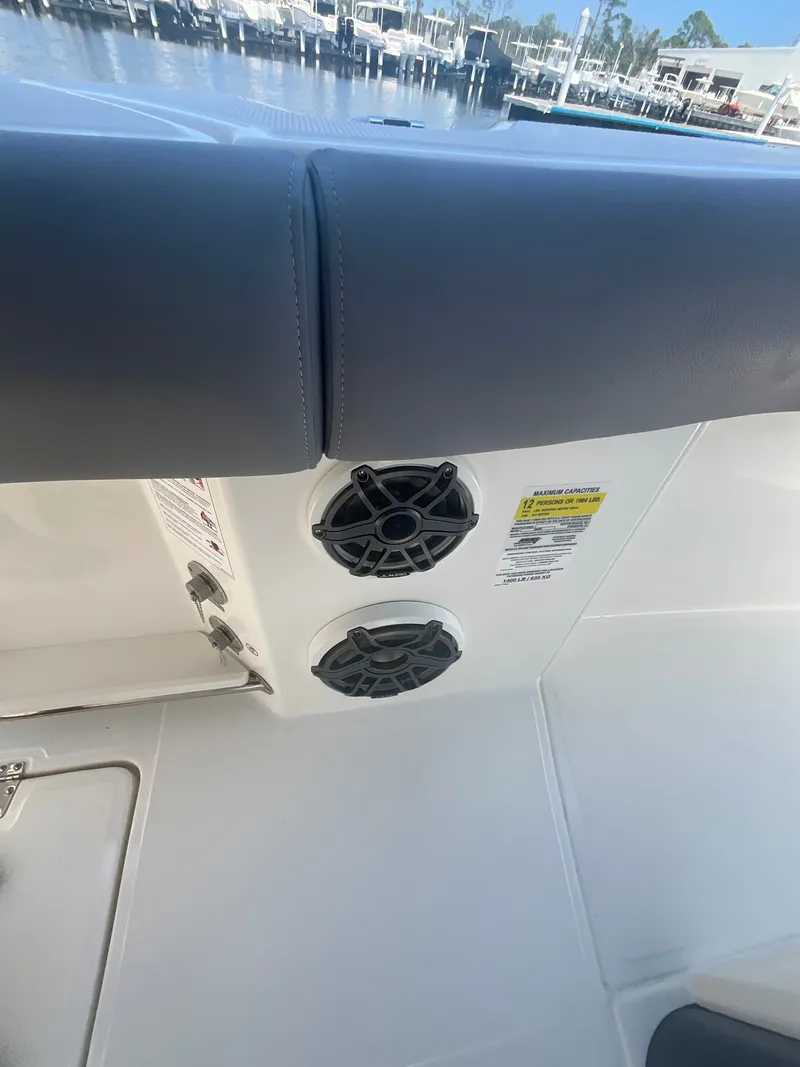 Slide: The Image of Close-up of speakers on a boat with gray upholstery and white deck. - 19