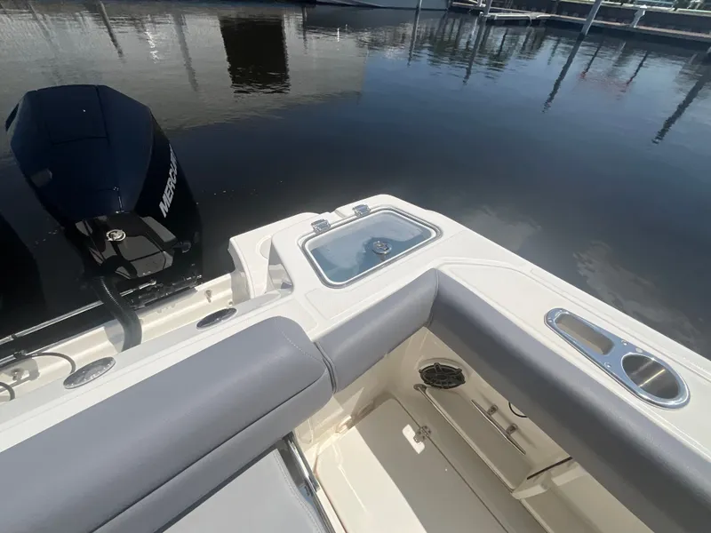 Slide: The Image of The image shows the stern of a 2027 Boston Whaler 250 Outrage with a Mercury outboard motor. - 9