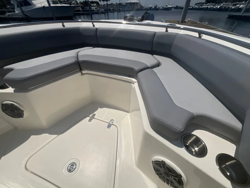 Slide: The Image of The 2027 Boston Whaler 250 Outrage features a spacious bow seating area with gray cushions. - 17