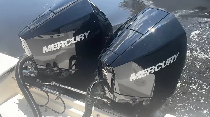 Slide: The Image of Two Mercury outboard engines are mounted on the stern of a boat in the water. - 4