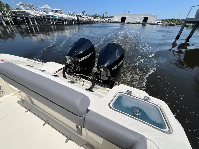 Slide: The Image of The image shows the stern of a Boston Whaler 250 Outrage with two Mercury engines in the water. - 5