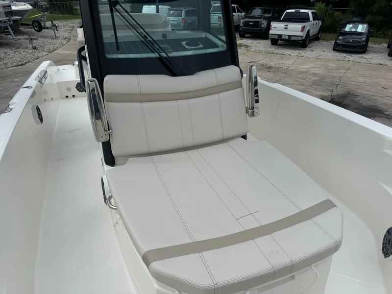 Slide: The Image of The 2027 Boston Whaler 280 Dauntless features a spacious, cushioned sun deck in the foreground. - 14
