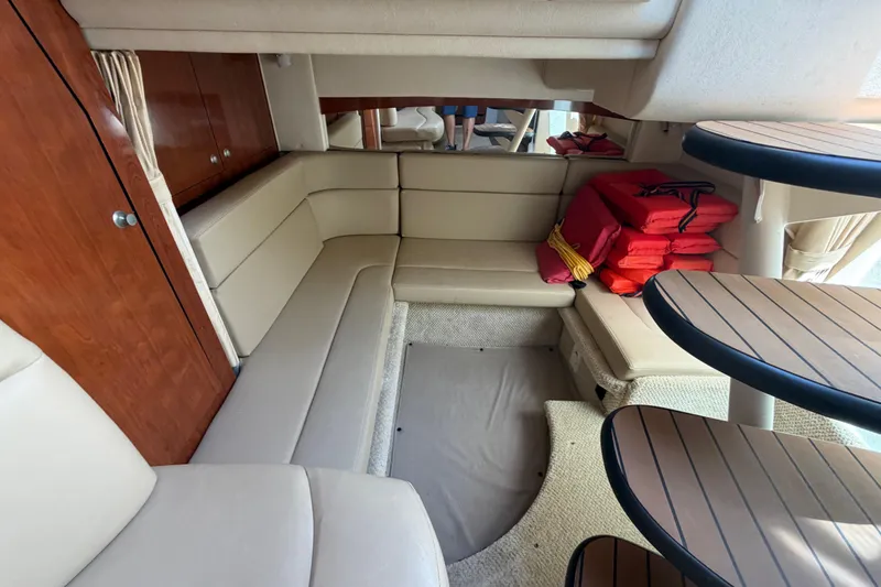 Slide: The Image of Interior of 2006 Sea Ray Sundancer 320 yacht with beige seating and life jackets. - 12