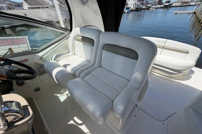 Slide: The Image of Interior of 2006 Sea Ray Sundancer 320 boat with white seating and waterfront view. - 13