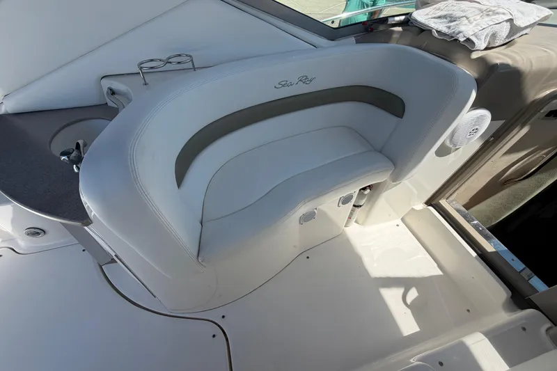 Slide: The Image of 2006 Sea Ray Sundancer 320 boat interior with white seating and cup holders. - 15