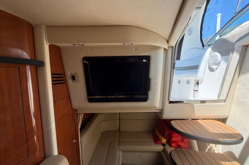 Slide: The Image of Interior of 2006 Sea Ray Sundancer 320 with TV, wooden cabinetry, and seating area. - 16