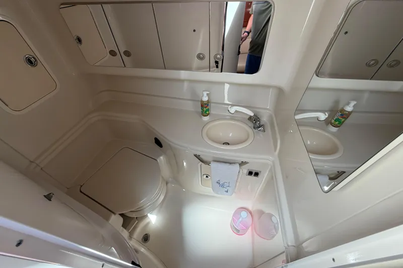 Slide: The Image of Bathroom interior of 2006 Sea Ray Sundancer 320 yacht, featuring sink, toilet, and mirror. - 17