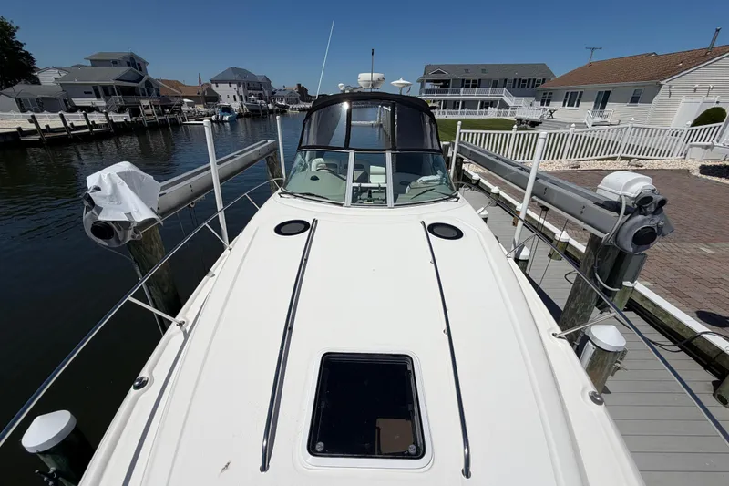 Slide: The Image of 2006 Sea Ray Sundancer 320 docked in a residential marina setting. - 18