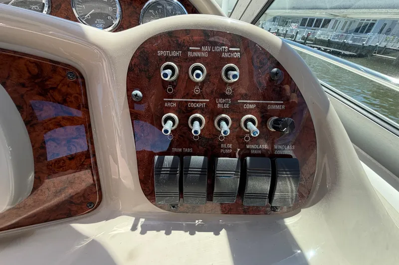 Slide: The Image of Control panel of a 2006 Sea Ray Sundancer 320 boat with various switches and dials. - 23