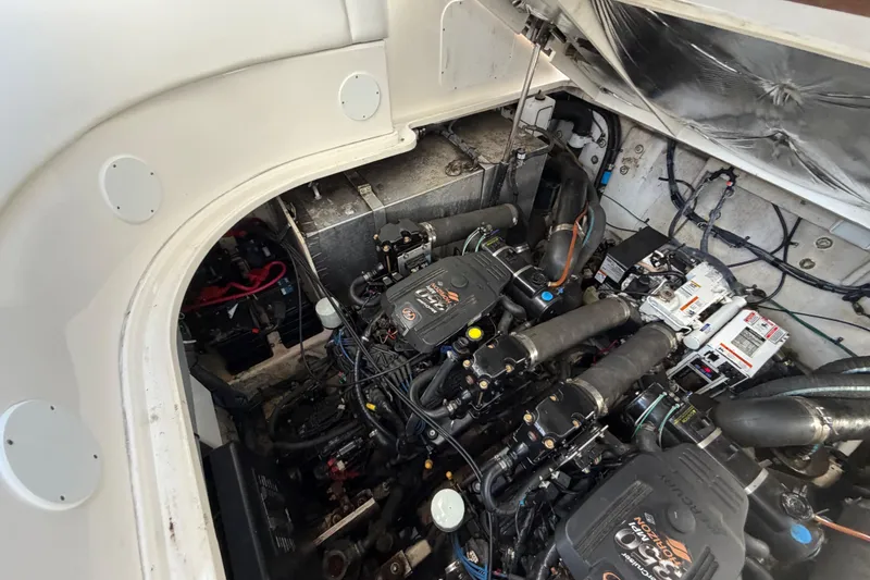 Slide: The Image of Engine compartment of a 2006 Sea Ray Sundancer 320, showcasing mechanical components and wiring. - 27