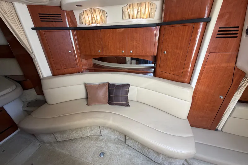 Slide: The Image of Luxurious interior of 2006 Sea Ray Sundancer 320 with curved seating and wooden cabinetry. - 8