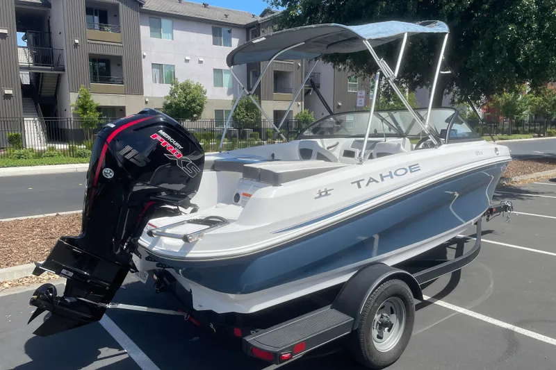 Slide: The Image of 2024 Tahoe 185 S boat with Mercury Pro XS engine in a parking lot. - 2