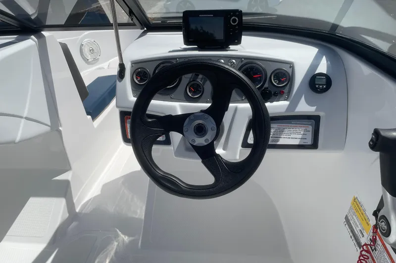 Slide: The Image of 2024 Tahoe 185 S boat dashboard with steering wheel and gauges. - 8