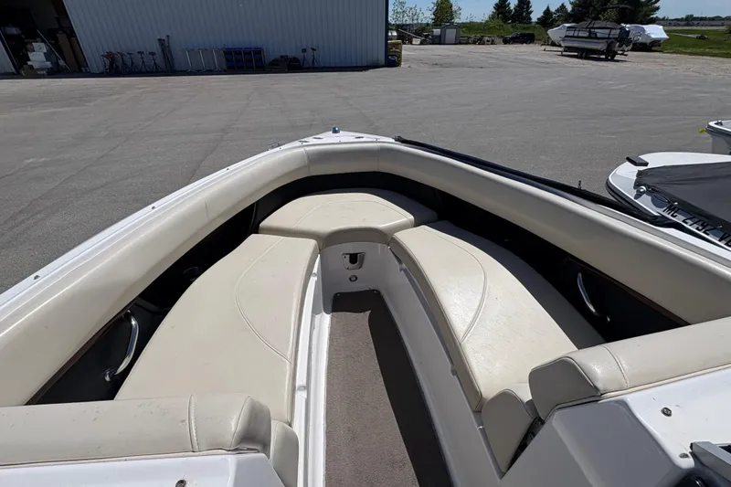 Slide: The Image of 2009 Regal 2500 Bowrider boat interior with white seating and open deck area. - 17