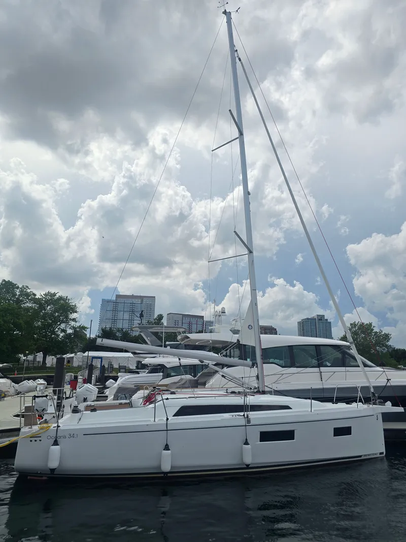 Slide: The Image of Beneteau Oceanis 34.1 2026 on a boat lift at the harbor. - 1
