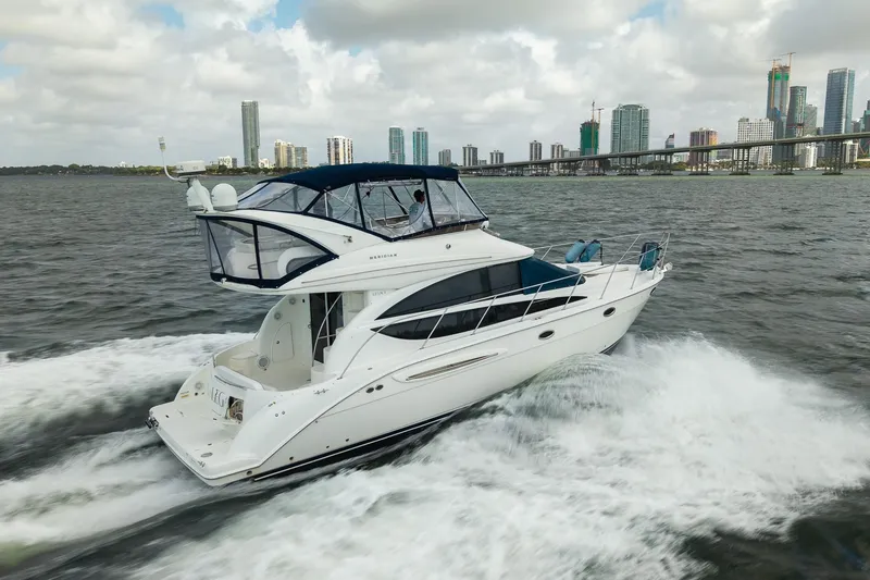The Image of 2009 Meridian 391 Sedan cruising on water with city skyline in background. - 0