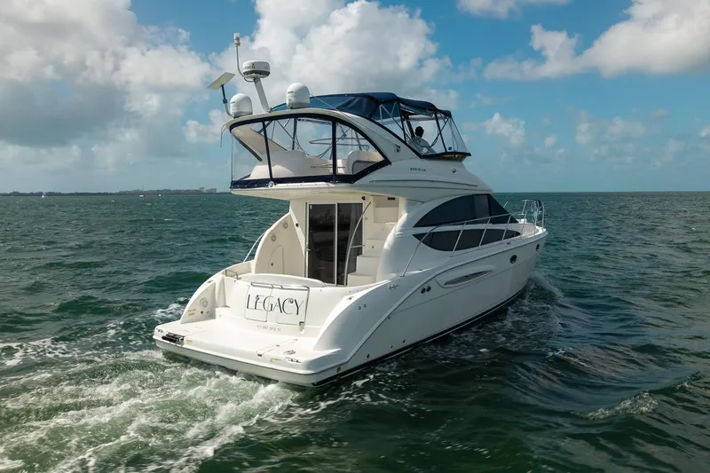 Slide: The Image of 2009 Meridian 391 Sedan yacht cruising on open water under a clear blue sky. - 1