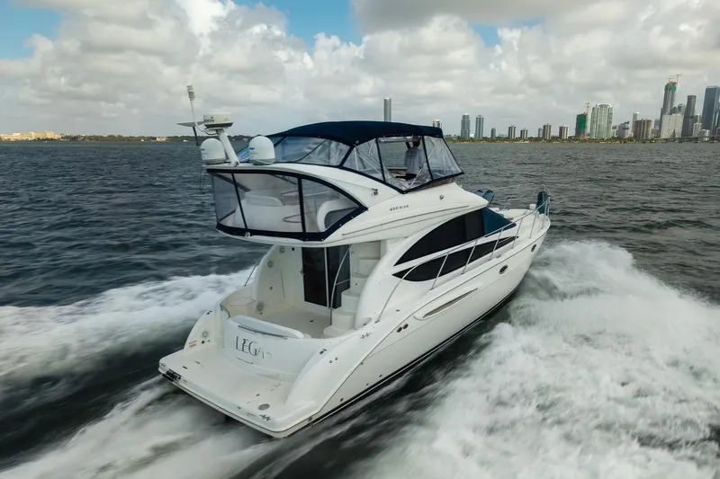 Slide: The Image of 2009 Meridian 391 Sedan cruising on water with city skyline in background. - 10