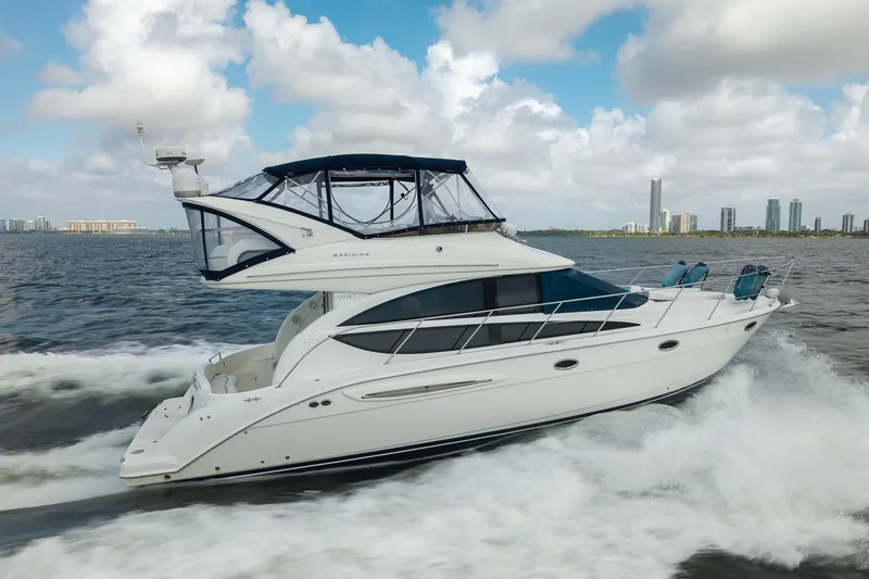 Slide: The Image of 2009 Meridian 391 Sedan cruising on water with city skyline in background. - 11