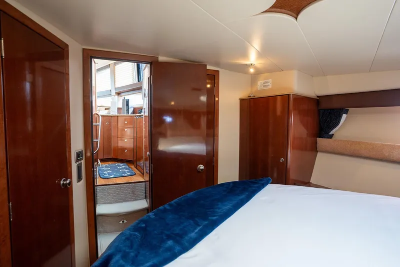 Slide: The Image of Luxurious interior of 2009 Meridian 391 Sedan yacht with wood finishes and cozy bedding. - 13