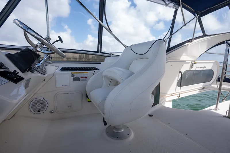 Slide: The Image of Captain's chair and helm of 2009 Meridian 391 Sedan yacht, with ocean view. - 16