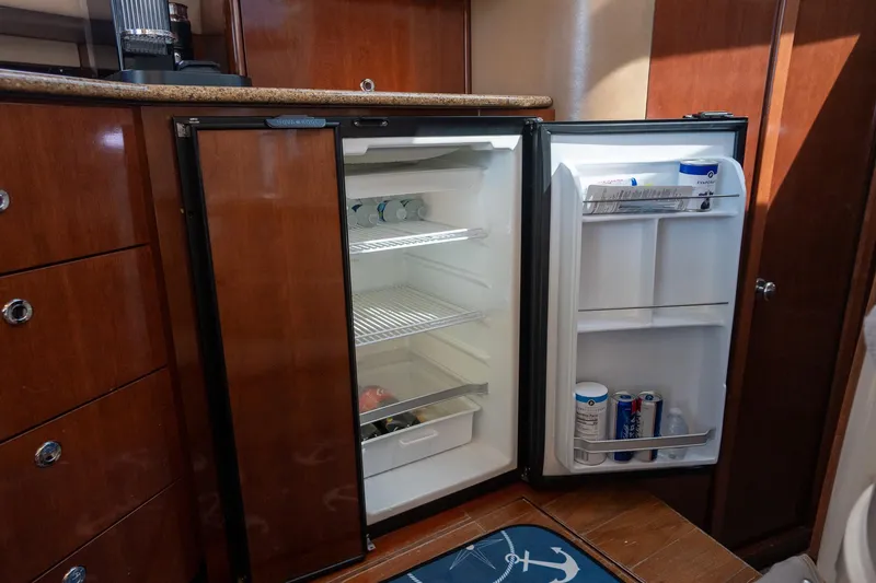 Slide: The Image of Open refrigerator in 2009 Meridian 391 Sedan yacht kitchen, showcasing interior storage. - 17