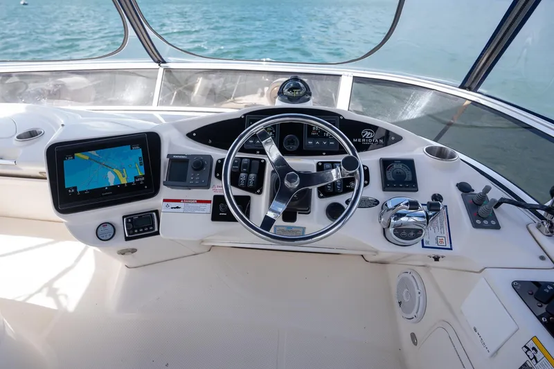 Slide: The Image of Cockpit of 2009 Meridian 391 Sedan yacht with navigation controls and steering wheel. - 18