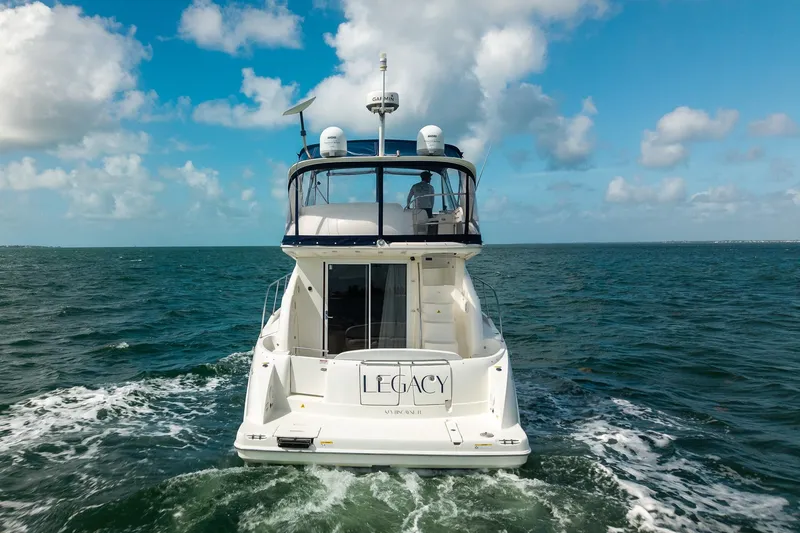 Slide: The Image of 2009 Meridian 391 Sedan yacht cruising on open water under a blue sky. - 2