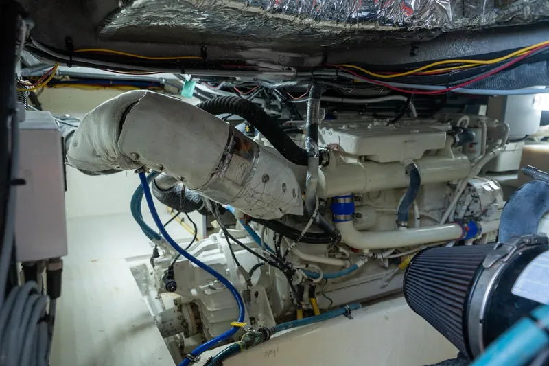 Slide: The Image of Engine room of a 2009 Meridian 391 Sedan yacht, showcasing mechanical components and wiring. - 24