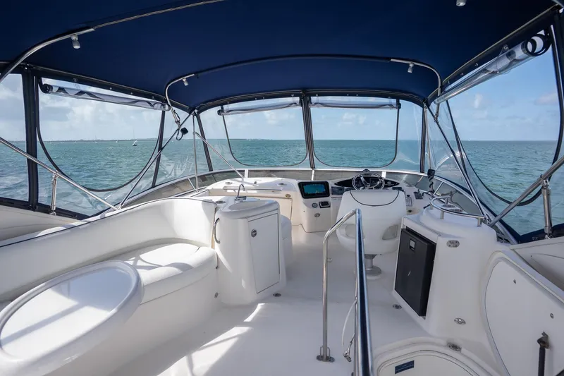 Slide: The Image of 2009 Meridian 391 Sedan yacht interior with ocean view, featuring helm and seating area. - 26