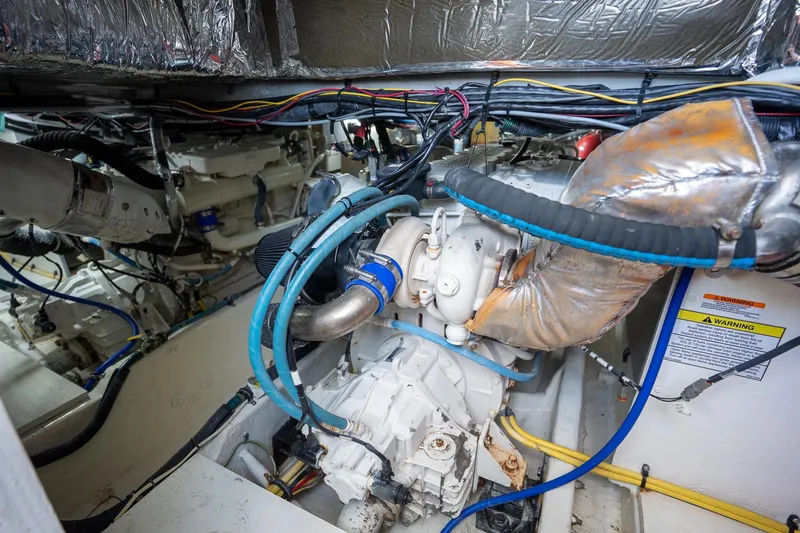 Slide: The Image of Engine room of a 2009 Meridian 391 Sedan yacht, showcasing mechanical components and wiring. - 27