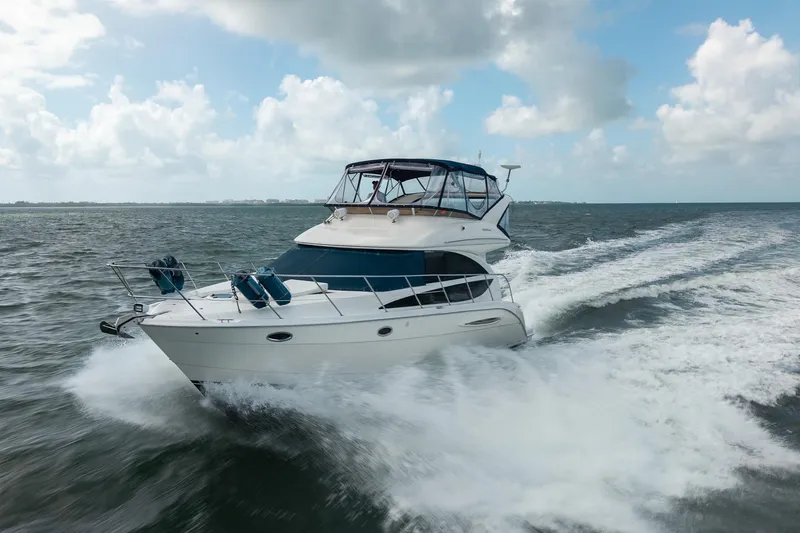 Slide: The Image of 2009 Meridian 391 Sedan cruising on open water under a partly cloudy sky. - 5