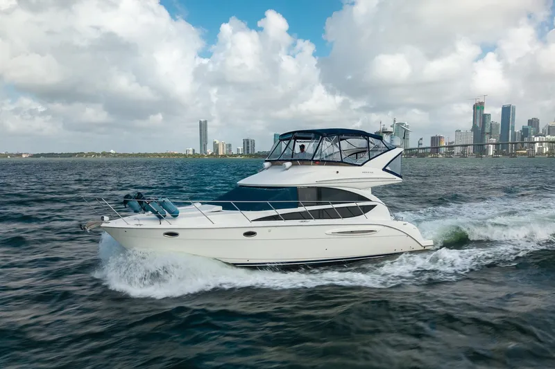 Slide: The Image of 2009 Meridian 391 Sedan cruising on water with city skyline in background. - 6