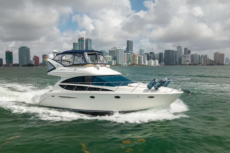 Slide: The Image of 2009 Meridian 391 Sedan cruising near city skyline on a sunny day. - 9