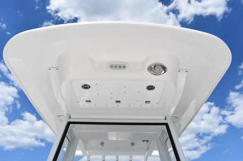 Slide: The Image of 2026 Sea Fox 248 Commander boat roof against a bright blue sky with clouds. - 10