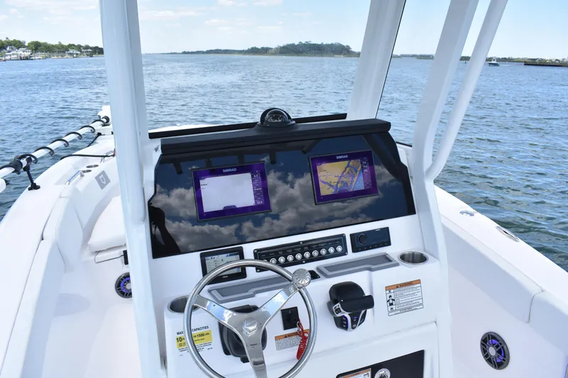 Slide: The Image of 2026 Sea Fox 248 Commander boat dashboard with navigation screens on open water. - 12
