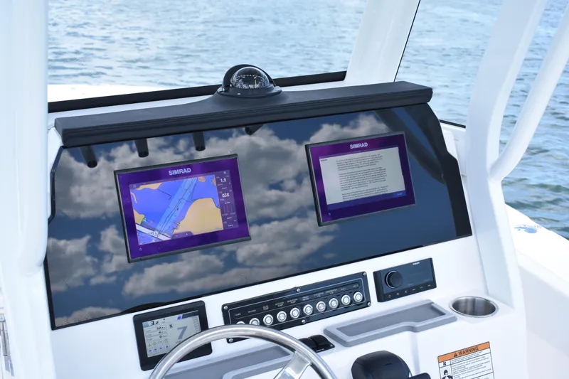 Slide: The Image of Dashboard of 2026 Sea Fox 248 Commander with dual Simrad displays on water. - 13