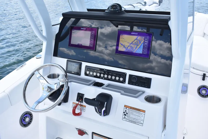 Slide: The Image of 2026 Sea Fox 248 Commander boat dashboard with navigation screens and steering wheel. - 14