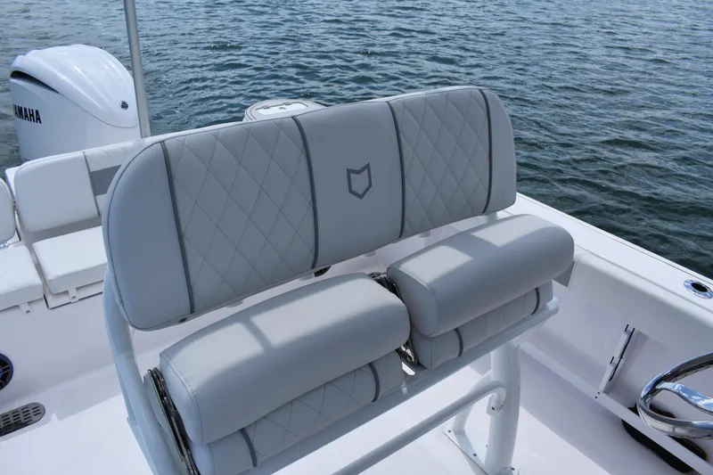 Slide: The Image of 2026 Sea Fox 248 Commander boat seating with diamond-stitched upholstery, on calm water. - 15