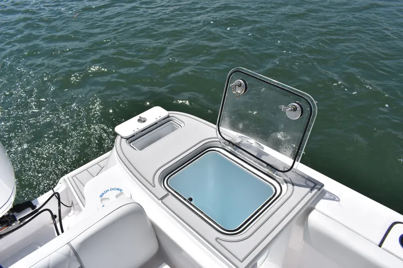 Slide: The Image of 2026 Sea Fox 248 Commander boat with open storage compartment on calm water. - 19