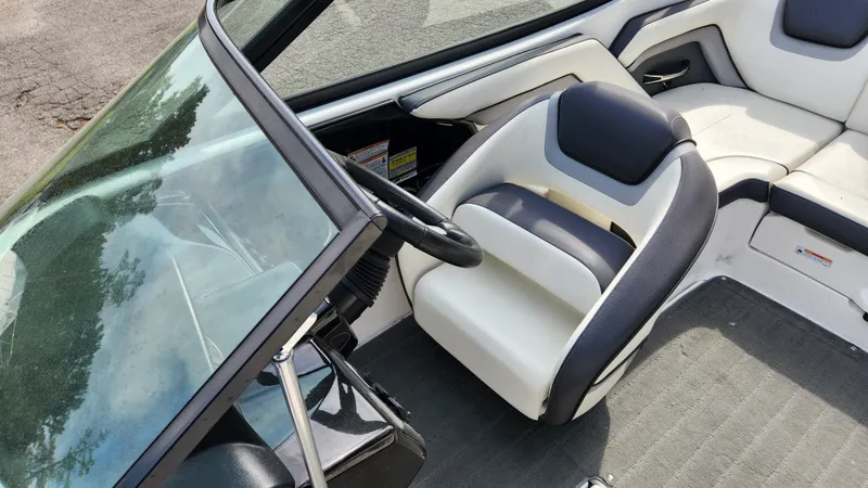 Slide: The Image of Interior of a 2016 Yamaha AR192 boat with steering wheel and seats. - 29