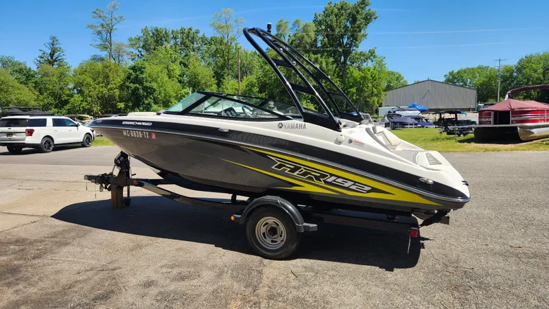 Slide: The Image of 2016 Yamaha AR192 boat parked on a trailer outdoors. - 31