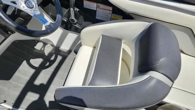 Slide: The Image of Interior of a 2016 Yamaha AR192 boat with steering wheel and seat. - 46