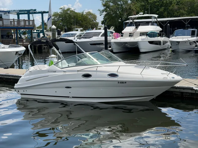 Slide: The Image of 2011 Sea Ray 240 Sundancer docked, white motorboat. - 0