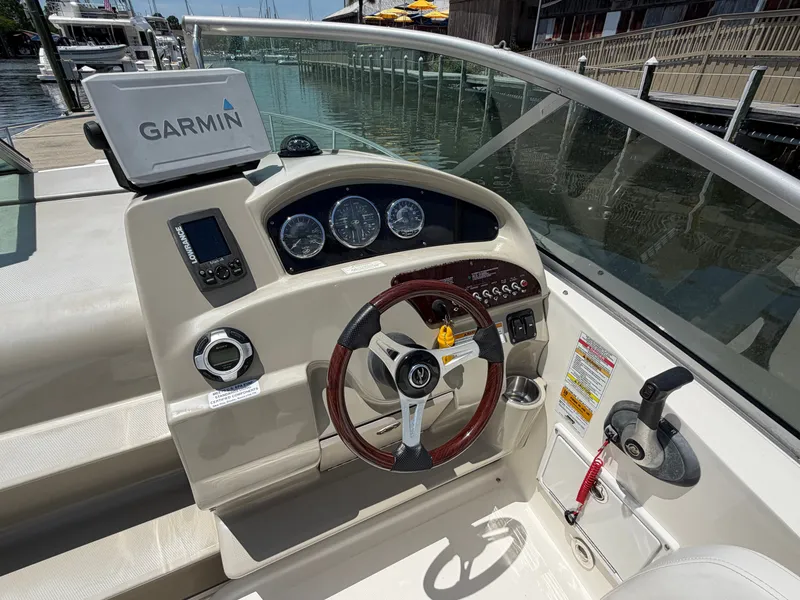 Slide: The Image of 2011 Sea Ray 240 Sundancer helm with Garmin navigation system. - 15