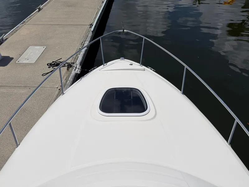 Slide: The Image of Bow of a 2011 Sea Ray 240 Sundancer boat at the dock. - 16