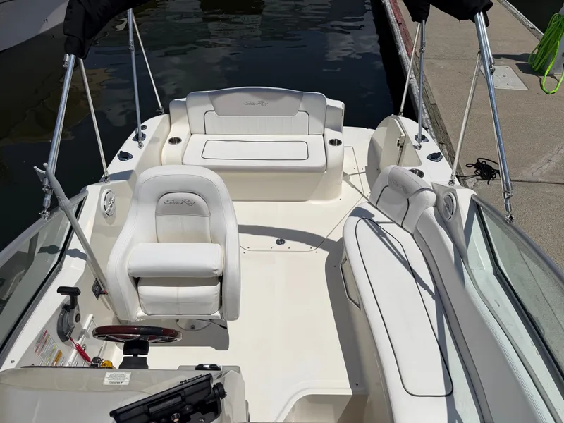 Slide: The Image of Interior of a 2011 Sea Ray 240 Sundancer with white seating. - 17