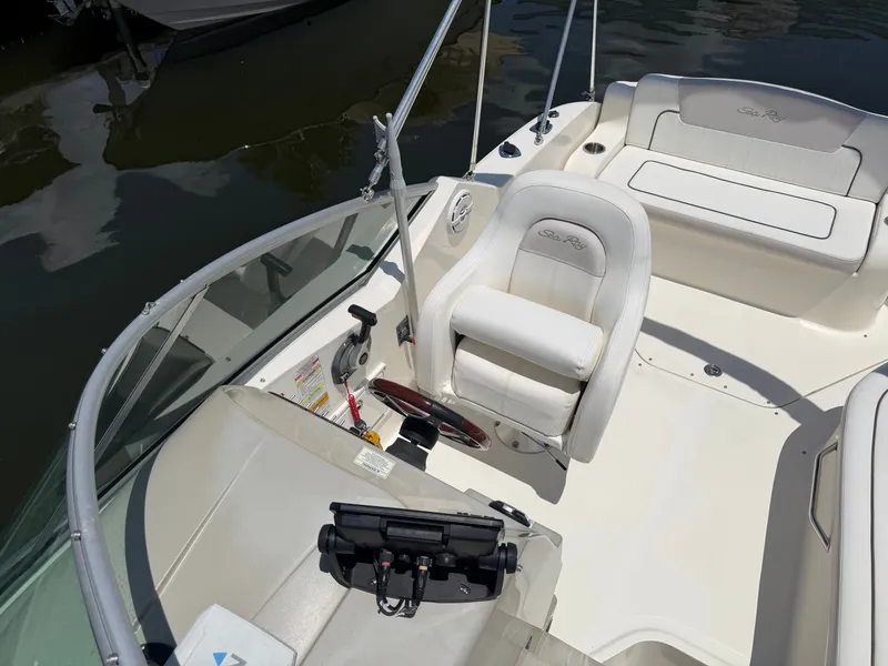 Slide: The Image of Interior of a 2011 Sea Ray 240 Sundancer with white seating. - 18